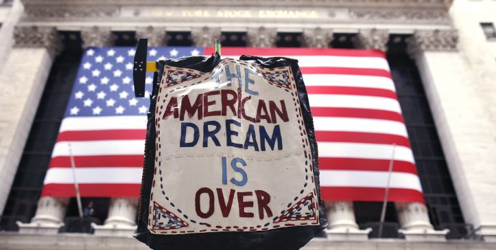 A demonstrator holds a sign reading "the American dream is over" during a rally outside Wall Street in New York April 4,2009.     REUTERS/Shannon Stapleton (UNITED STATES BUSINESS SOCIETY IMAGE OF THE DAY TOP PICTURE)